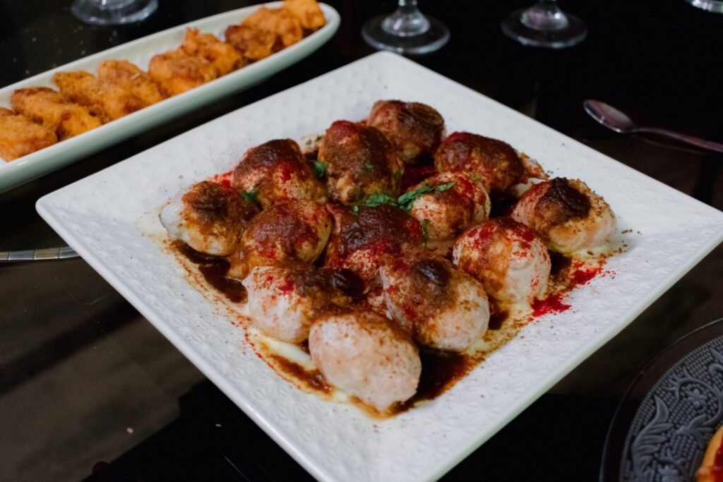 Tasty Indian dahi vada served on a square plate capturing the essence of Indian cuisine.
