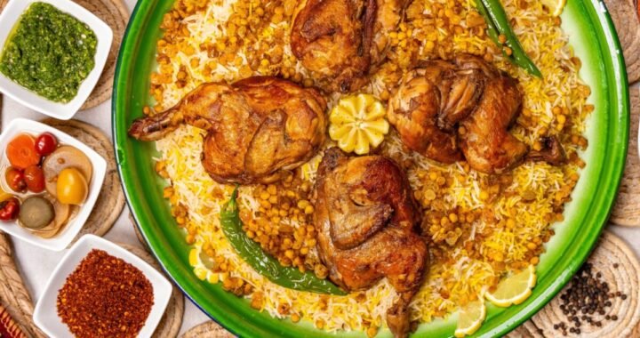 Savory roasted chicken on a bed of rice with lentils, accented by spicy and fresh green sides.