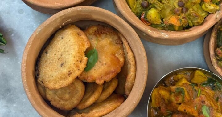 Top view of clay pots with a variety of Indian vegetarian dishes, ideal for food enthusiasts.