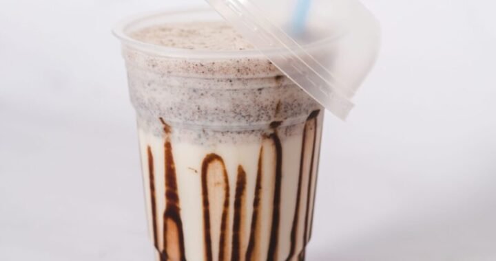 Delicious iced chocolate shake in a clear plastic cup with a straw, perfect for summer cravings.