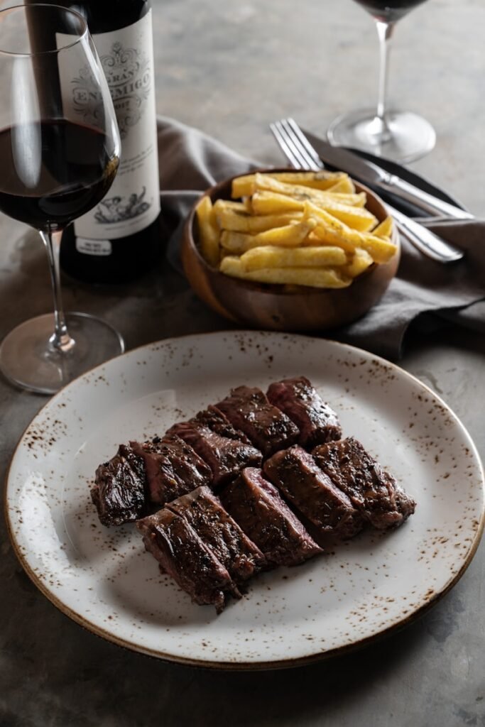 a plate of food and a glass of wine on a table