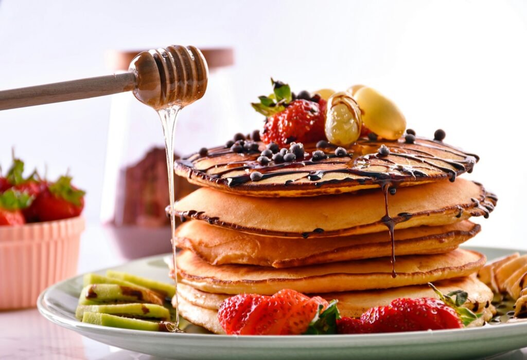 a stack of pancakes with fruit on top