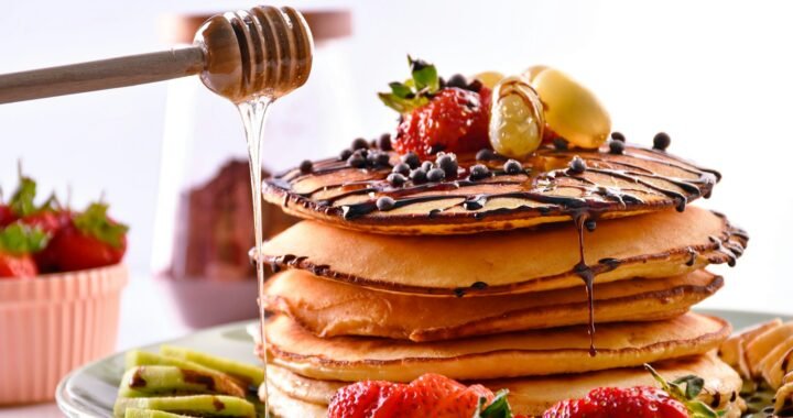 a stack of pancakes with fruit on top